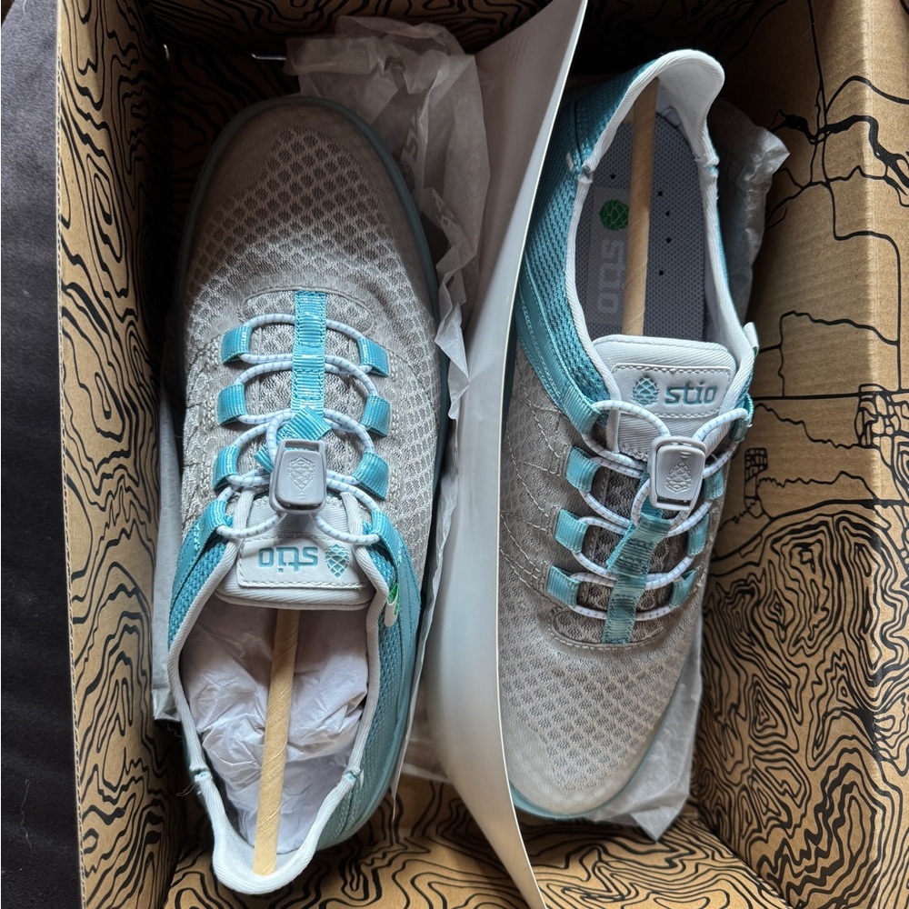 stio grey and light blue water shoe with slip on back.